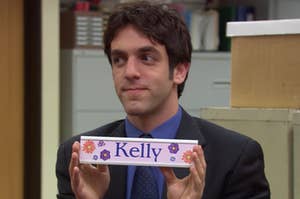 Ryan holding up a nameplate that says Kelly