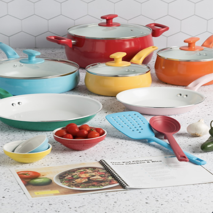 An array of large and small pots and pans, all with glass lids, sit atop a kitchen counter. 