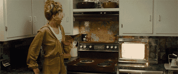 GIF of Jennifer Lawrence in American Hustle reacting to a toaster oven catching fire 