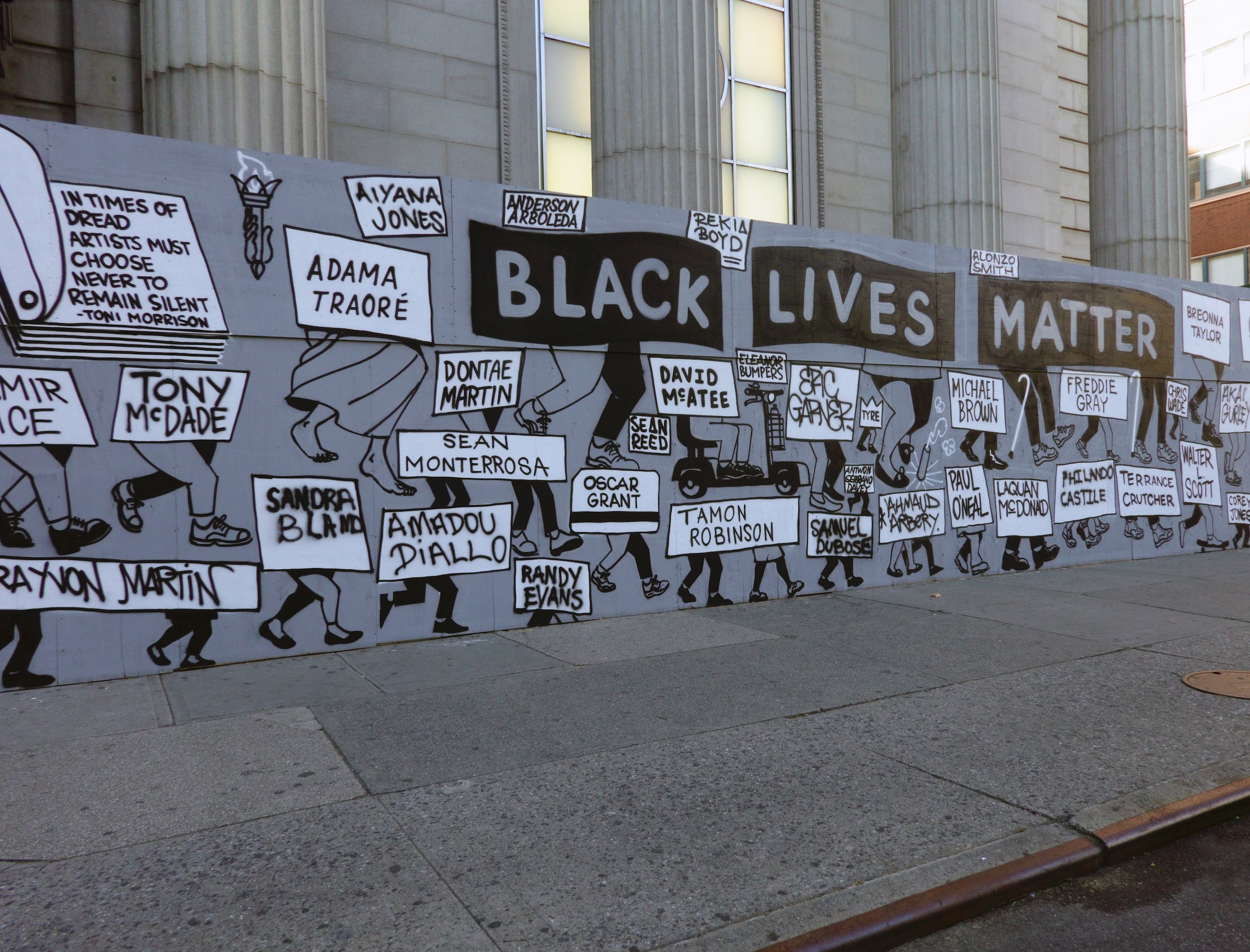 A wall painted to say &quot;Black Lives Matter,&quot; with painted signs that read the names of victims of police brutality and killings