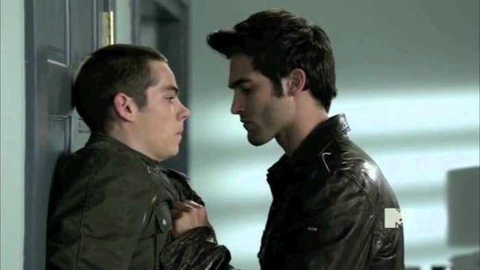 Derek pins Stiles against a wall