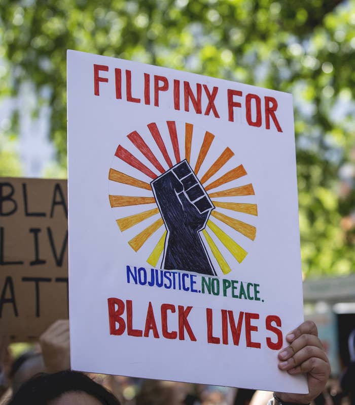 A protest sign that says, &quot;Filipinx for Black Lives. No justice. No peace,&quot; with an illustration of a fist