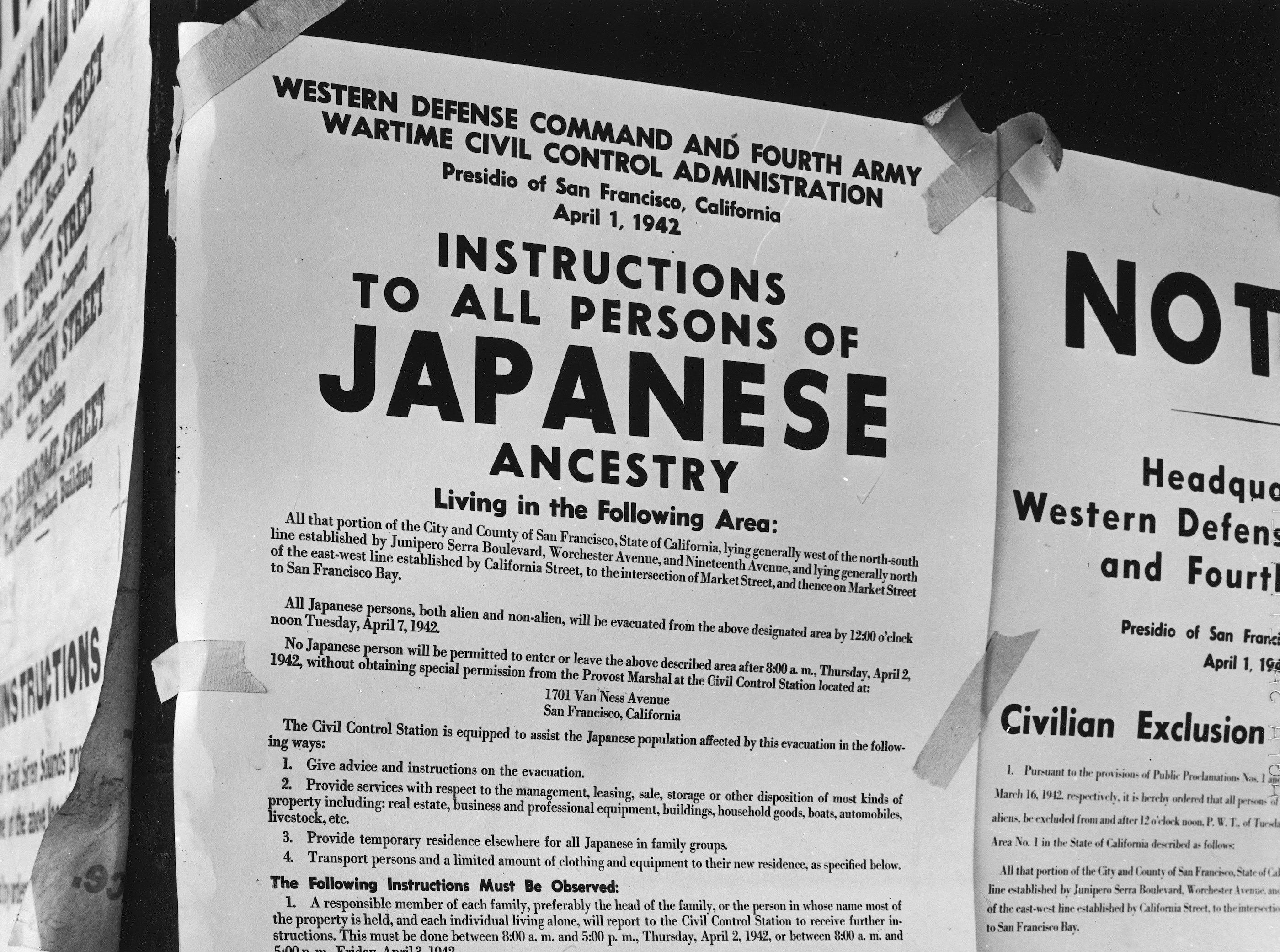 A flyer taped to a building in San Francisco that reads, &quot;Instructions To All Persons Of Japanese Ancestry,&quot; and orders them to be evacuated to internment camps