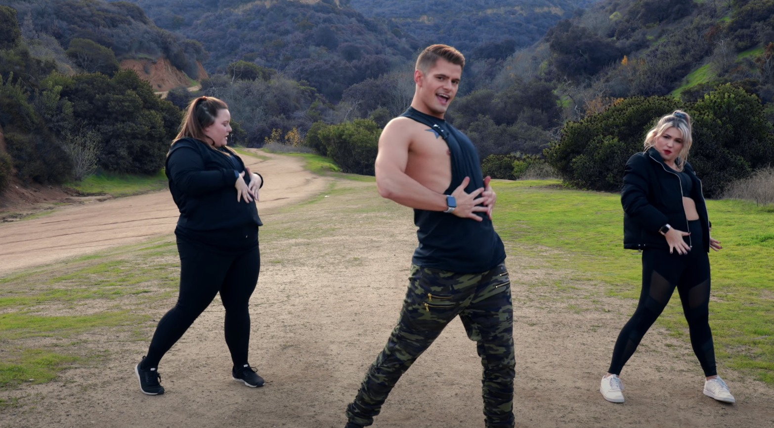 YouTuber The Fitness Marshall doing a dance workout with two people