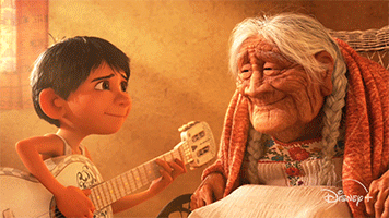 Miguel playing the guitar for his grandma.