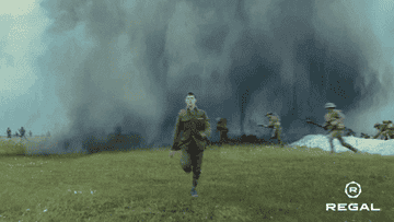 Lance Corporal Schofield sprinting through a battle field.