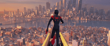 Miles jumping off a building dressed as Spiderman.
