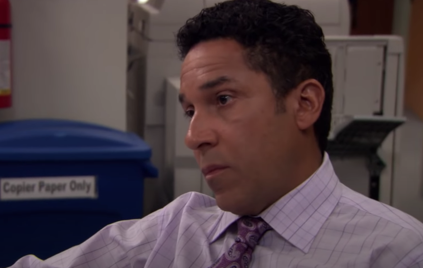 Oscar from "The Office" looks upset.