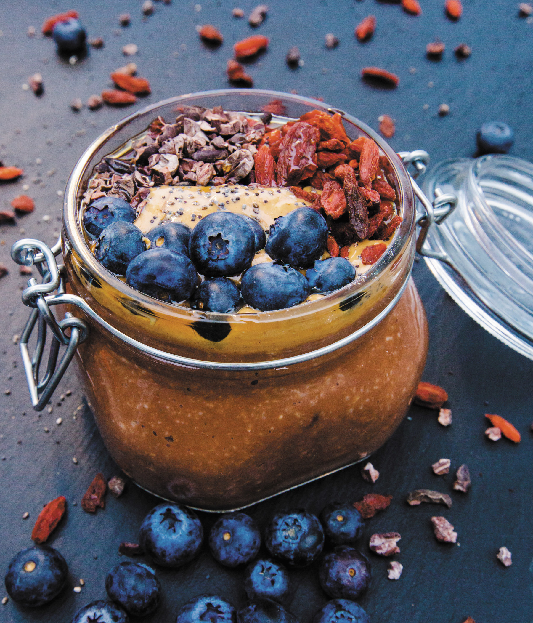 Chocolate overnight oats with blueberries, goji berries, chia seeds, and cacao nibs.