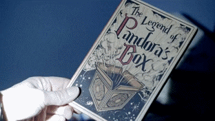 A woman holding a book that says &quot;The Legend of Pandora&#x27;s Box&quot;