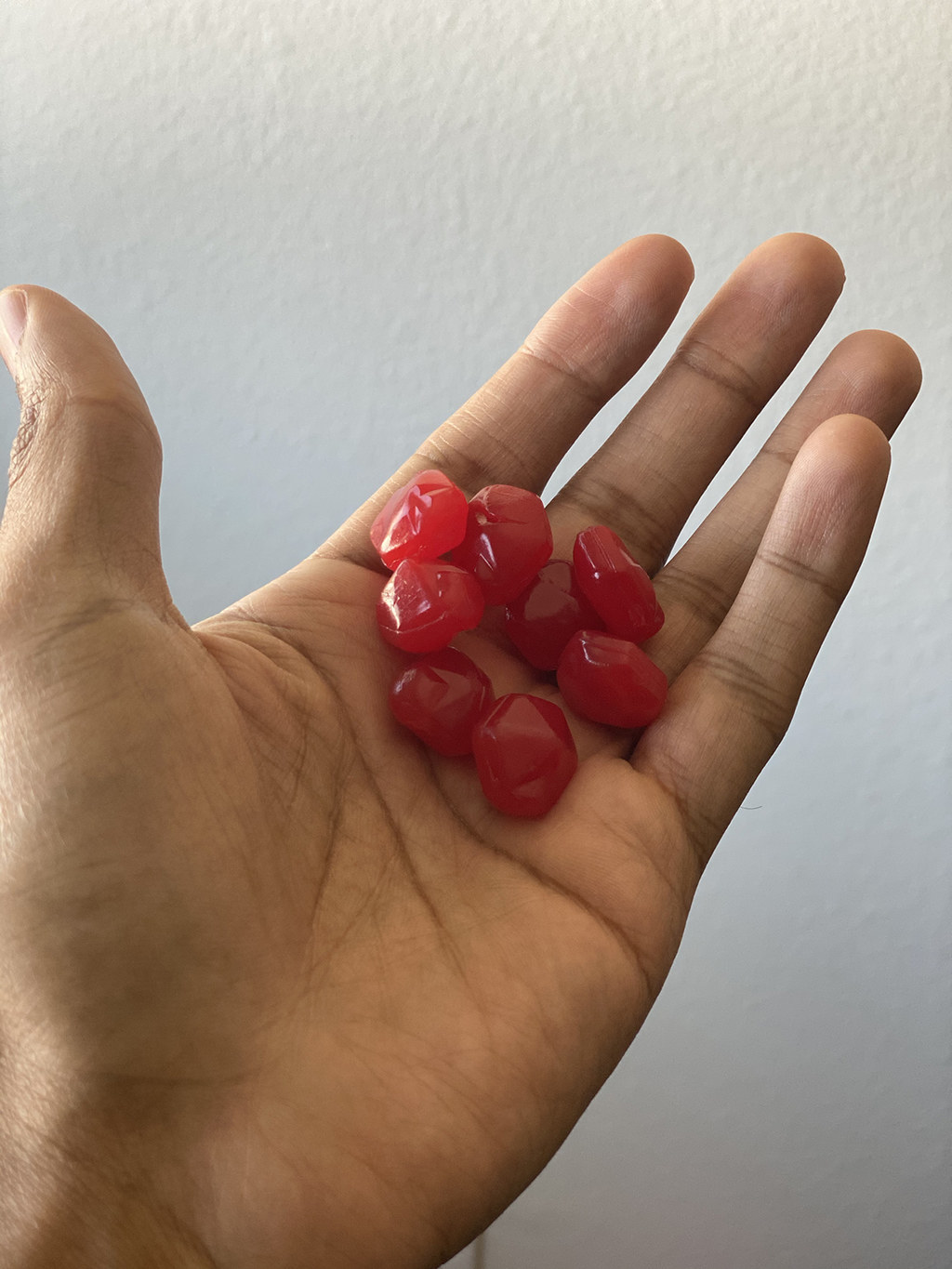 A hand holding Fruit Gushers outside of their package
