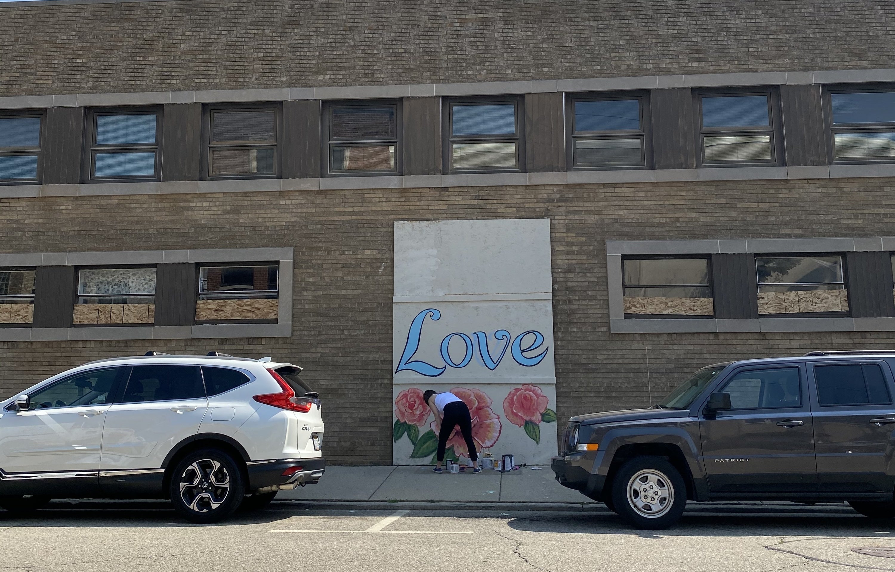 A mural says &quot;Love&quot; with flowers below