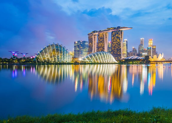 The Singapore skyline at night over the water's surface