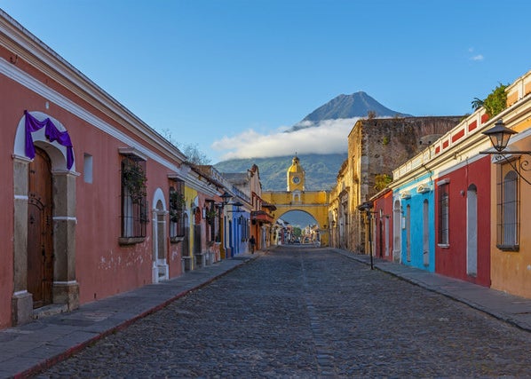 Street view of colourful houses with a beautiful mountain in the background