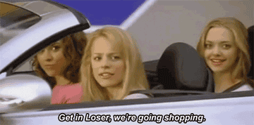 A GIF of a person sitting in their car and saying get in loser, we&#x27;re going shopping