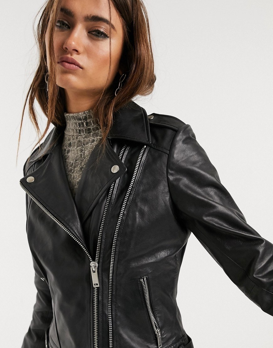 Model in a zipped-up black leather motorcycle jacket