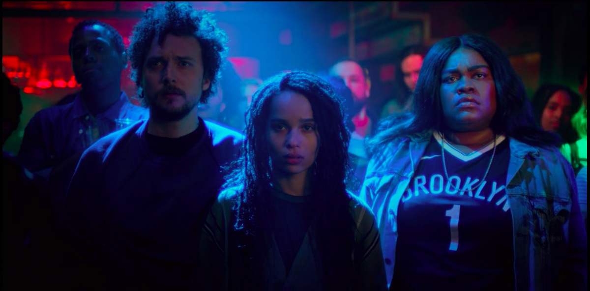 A &quot;High Fidelity&quot; still of David H. Holmes, Zöe Kravitz, and Da&#x27;Vine Joy Randolph standing in the crowd of a concert