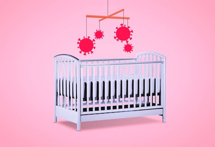 A mobile with Coronavirus molecules hangs over a baby's crib.
