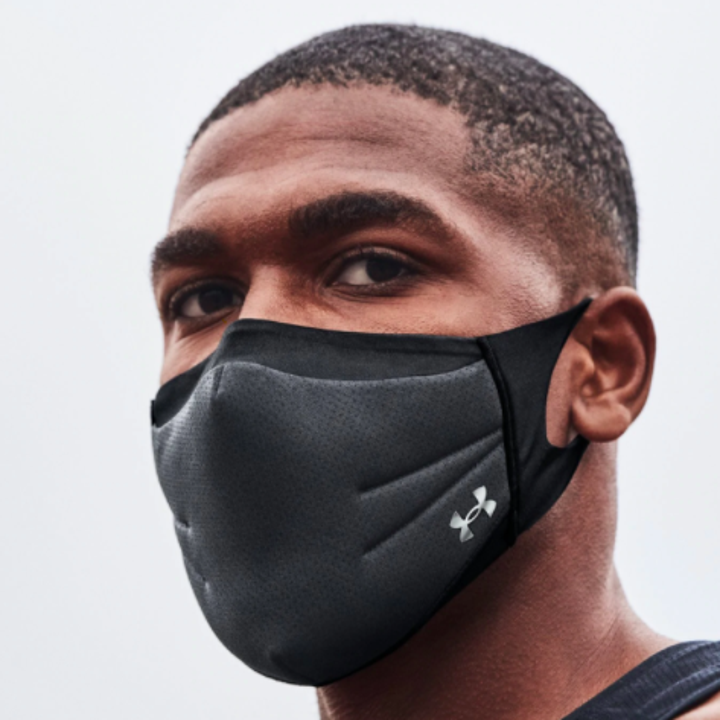 A close up of a person wearing the face mask
