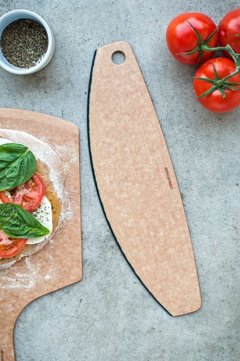 A flatlay of the pizza cutter next to a fresh pizza
