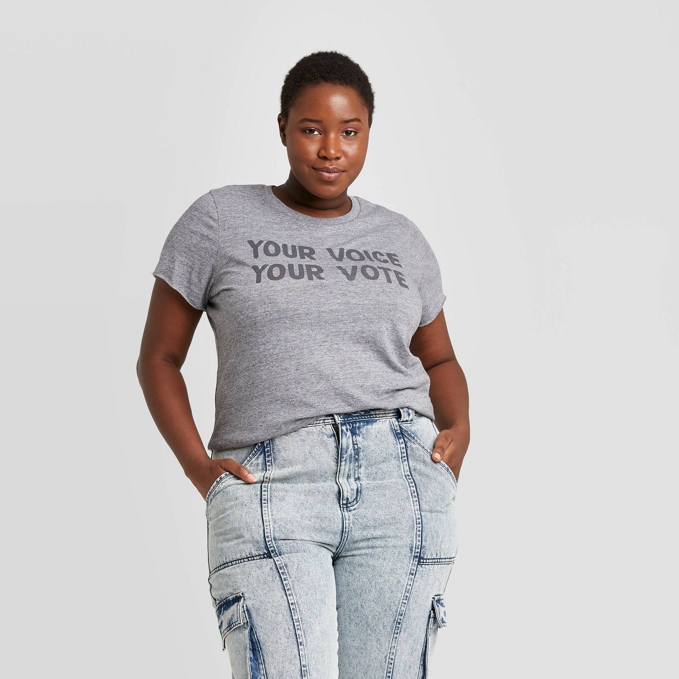 Model wearing gray tee with &quot;Your Voice Your Vote&quot; design