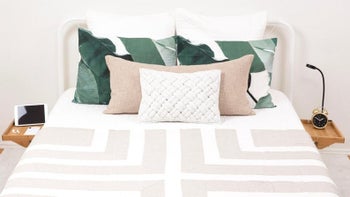 photo of two bedside tables attached to each side of the bed frame and holding different things