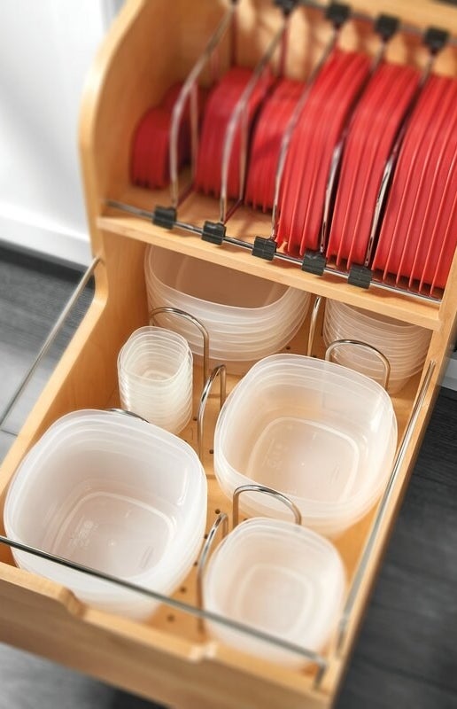 A wooden pull-out drawer holding food containers