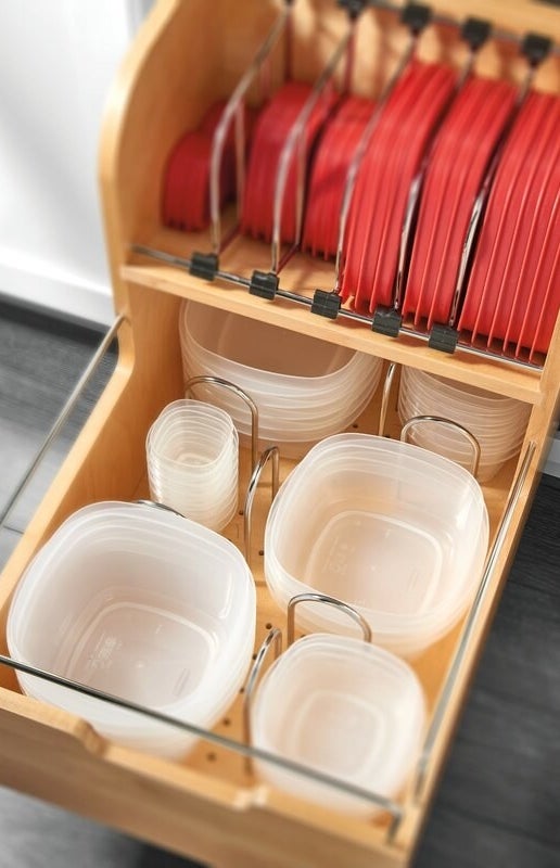 A wooden pull-out drawer holding food containers