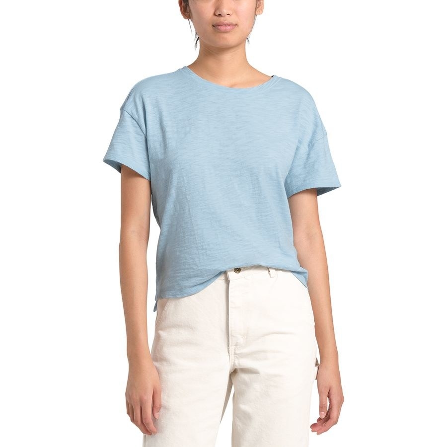 A model in a light blue heathered T-shirt