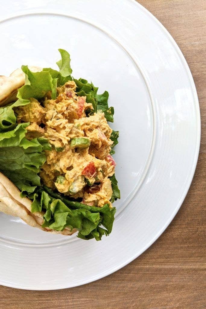 A pita filled with curried tuna salad and lettuce.