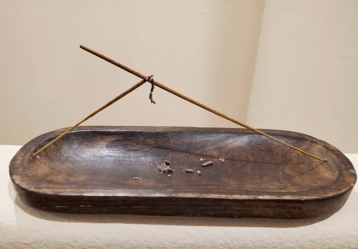 a rounded wooden incense holder