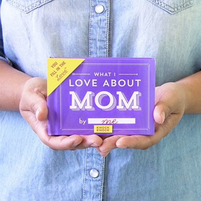 Hands holding the palm-sized &quot;What I Love About Mom&quot; book