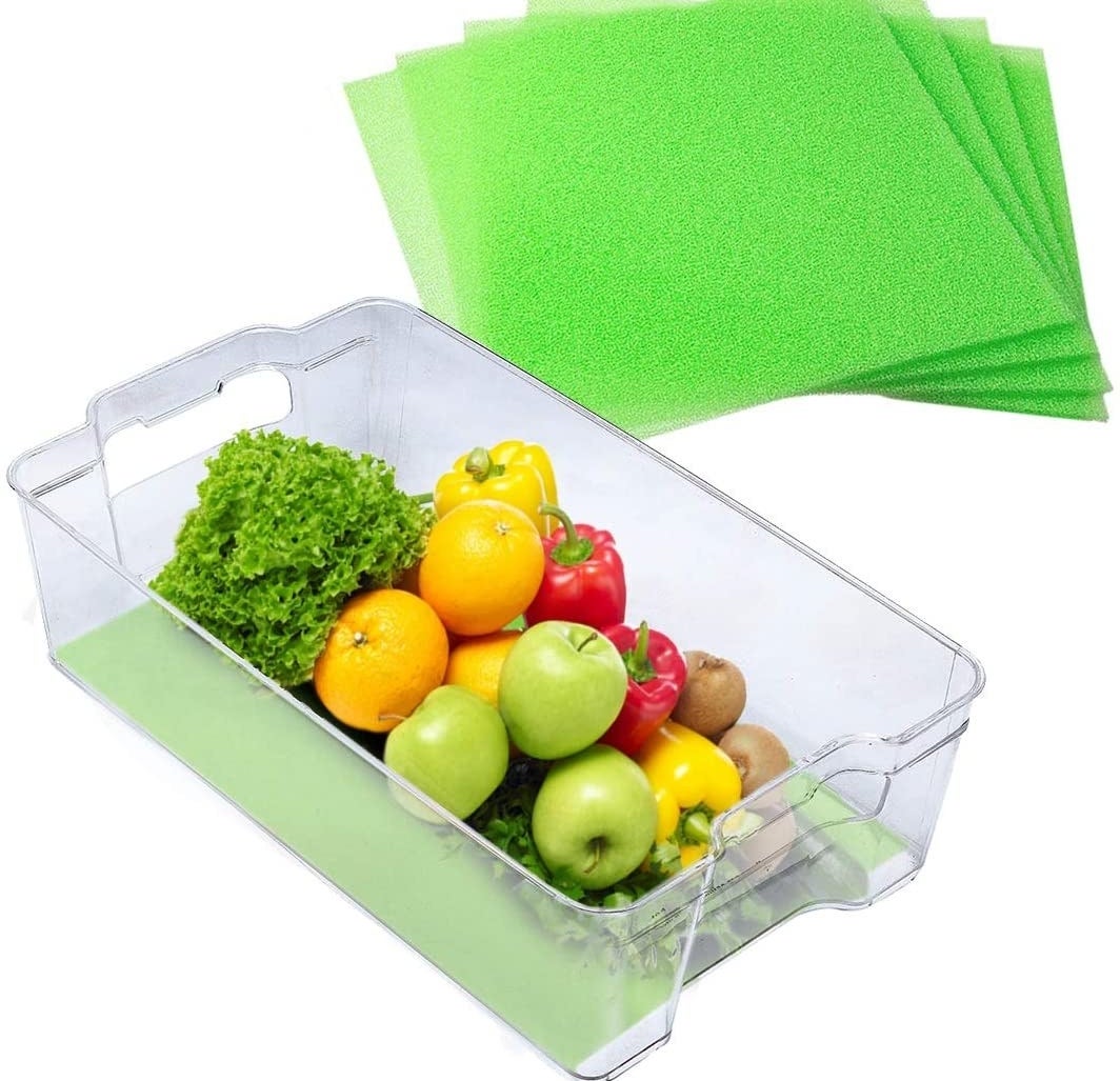 A crisper drawer of produce with a liner underneath