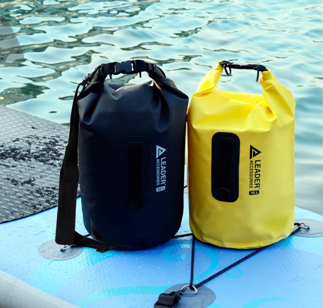 A black and yellow vinyl bag sitting on a kayak