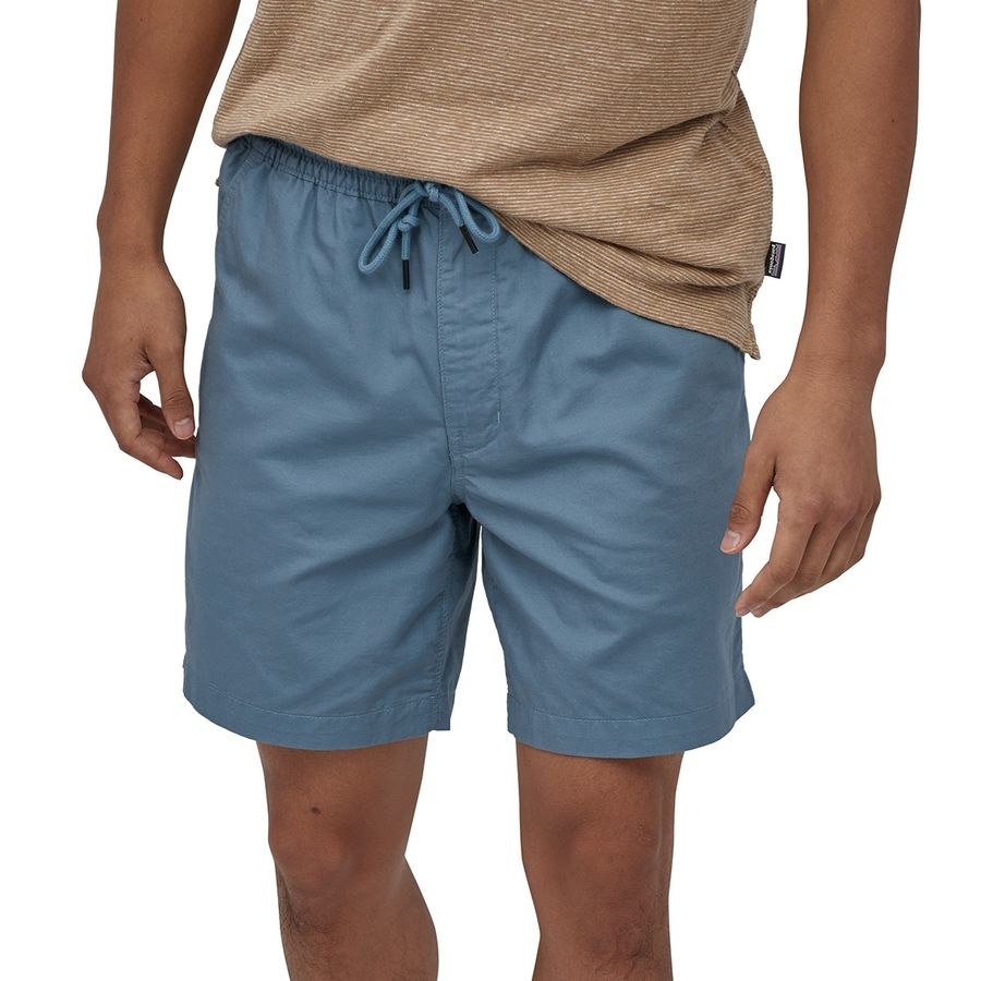 A model in blue drawstring shorts that fall at the knee 