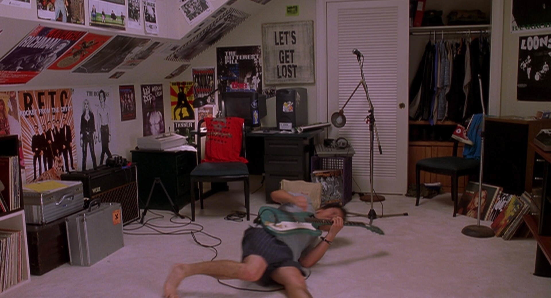 Cliff plays guitar on the floor. 