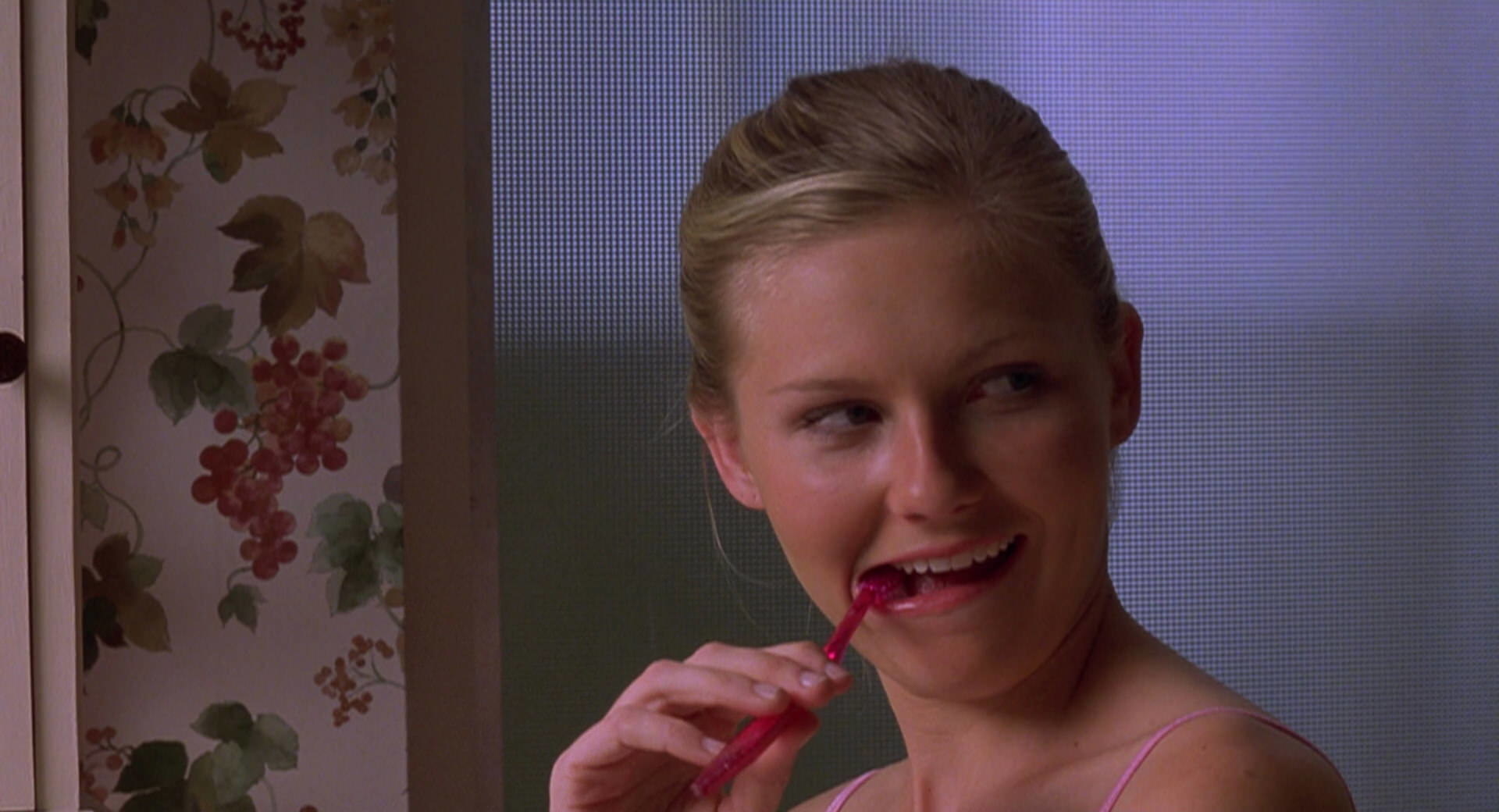 Torrance looking at Cliff with a toothbrush in her mouth.