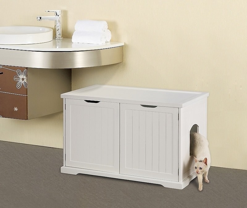 A large litter box that looks like a washroom cupboard and has a side door for the cat to enter and exit
