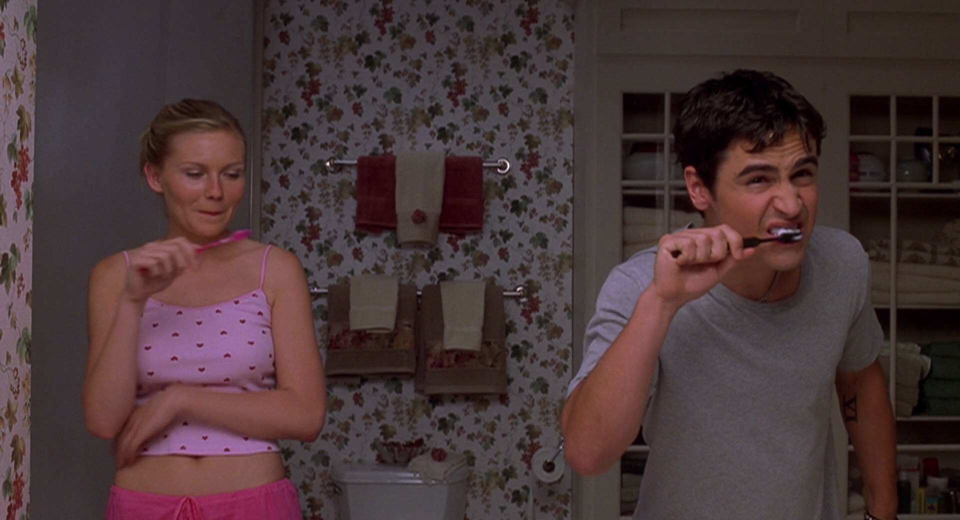 Torrance and Cliff brushing their teeth at the sink.