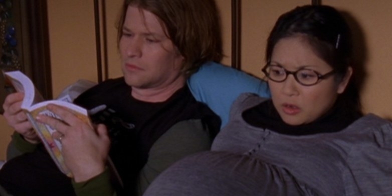 heavily pregnant Lane lying down with her husband Zach