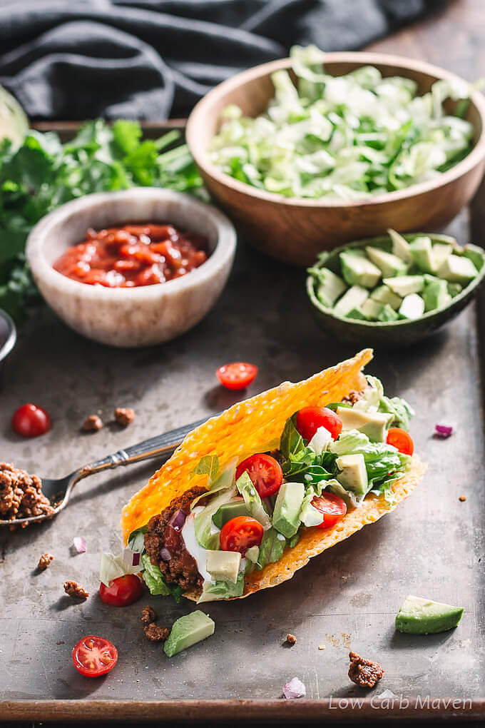 Keto ground beef tacos topped with tomatoes and avocado