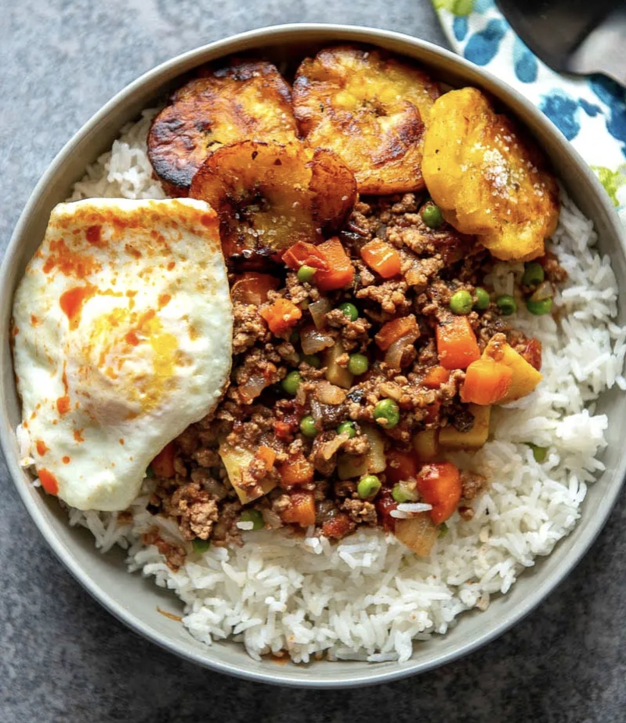 Filipino picadillo served over rice and with a fried egg on the side