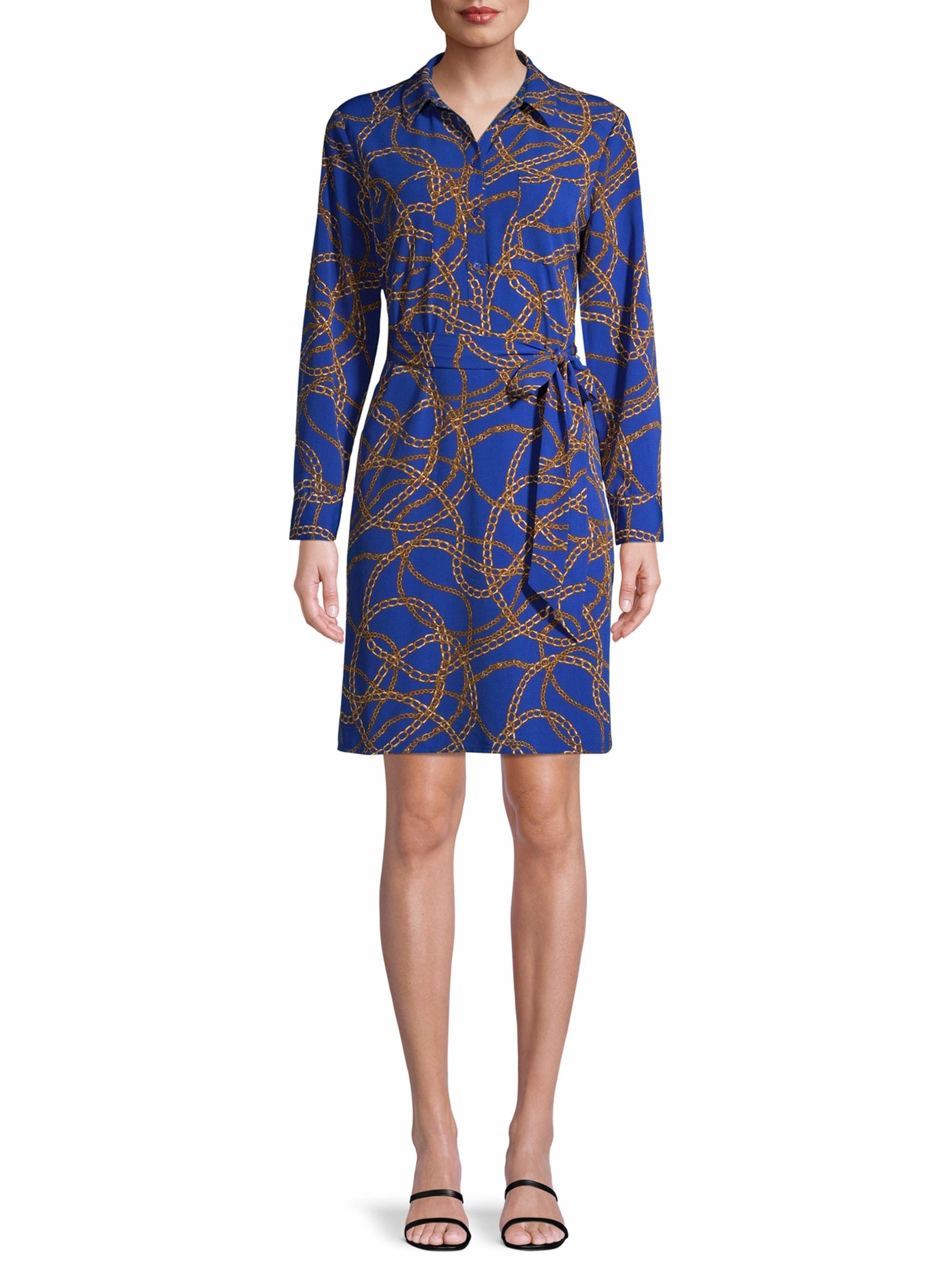  A model wearing the royal blue long-sleeve dress with a chain print design
