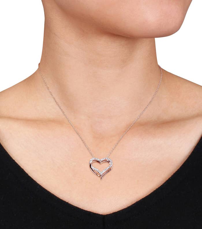 A model wearing a rose gold rhinestone heart pendant
