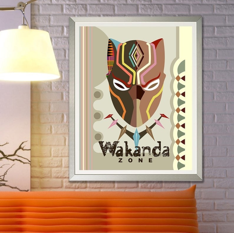 A stylized picture of black panther&#x27;s mask on a print with the words Wakanda Zone