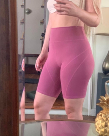 Reviewer shows front view of same pair of bike shorts while taking a mirror selfie
