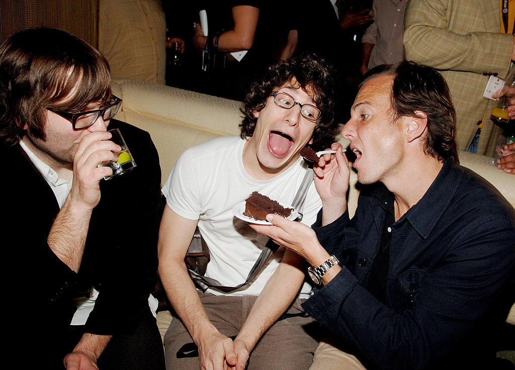 Will Arnett feeding Andy Samberg cake as Ben Gibbard watches