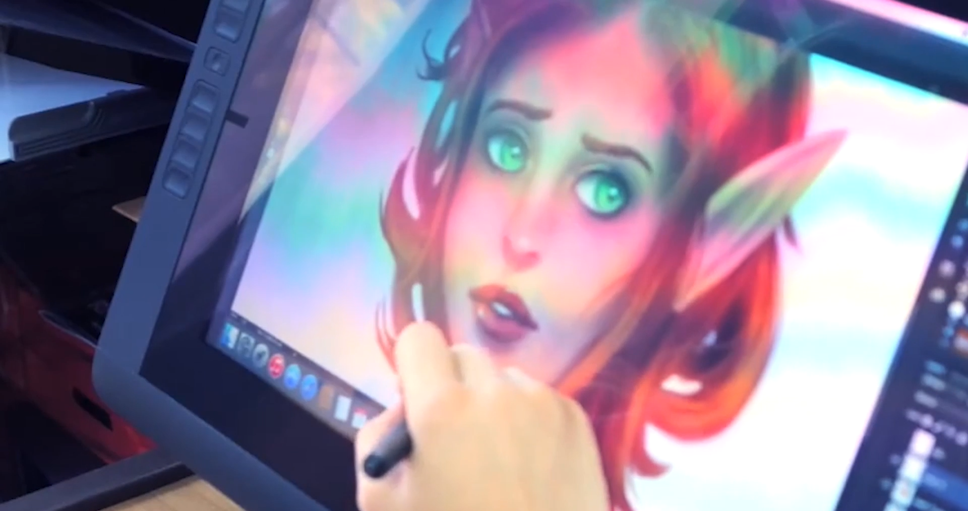 A person colouring a picture of a person on a computer screen