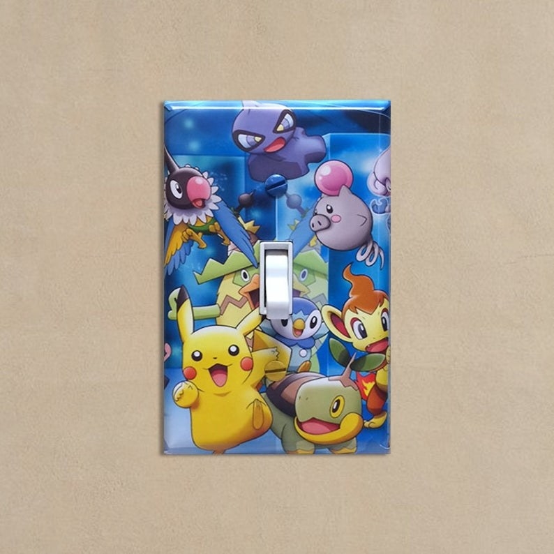 A lightswitch cover with Pikachu and other Pokemon