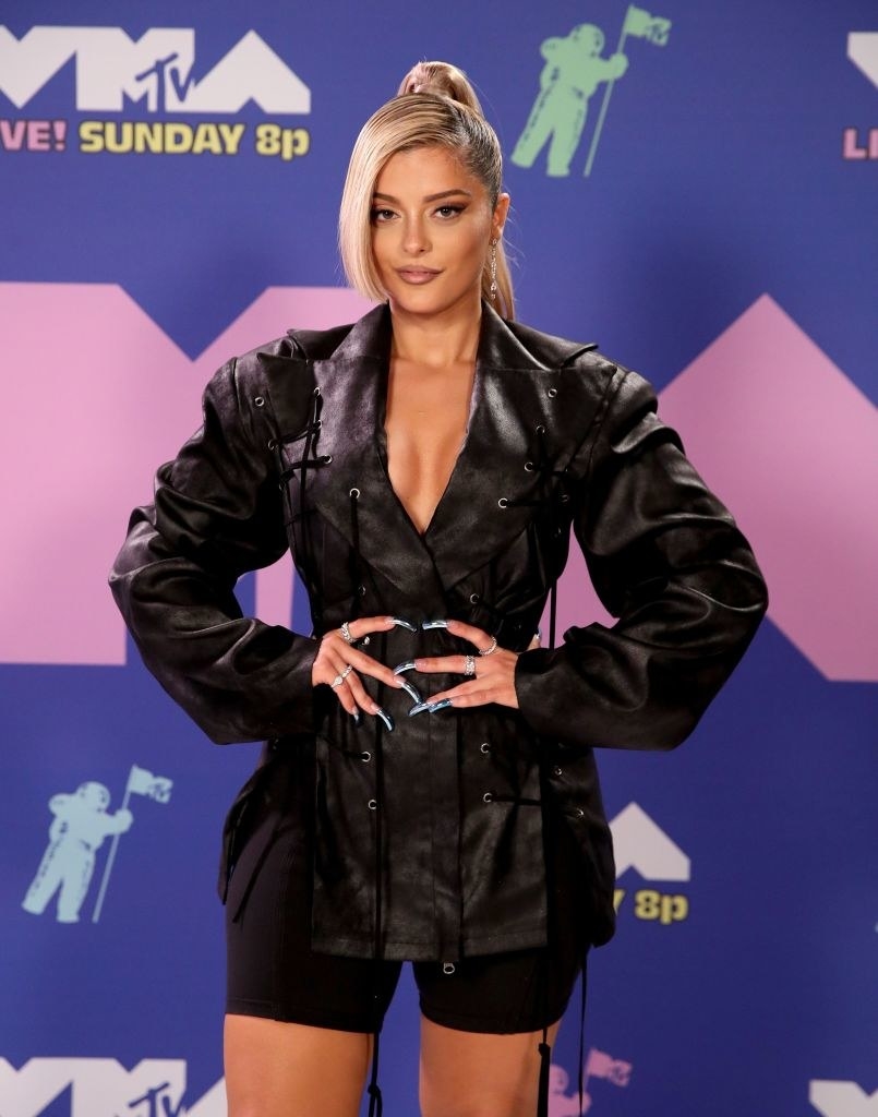 Bebe Rexha posed in a leather jacket dress